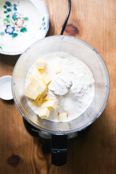 Dry ingredients in a food processor with cubed butter