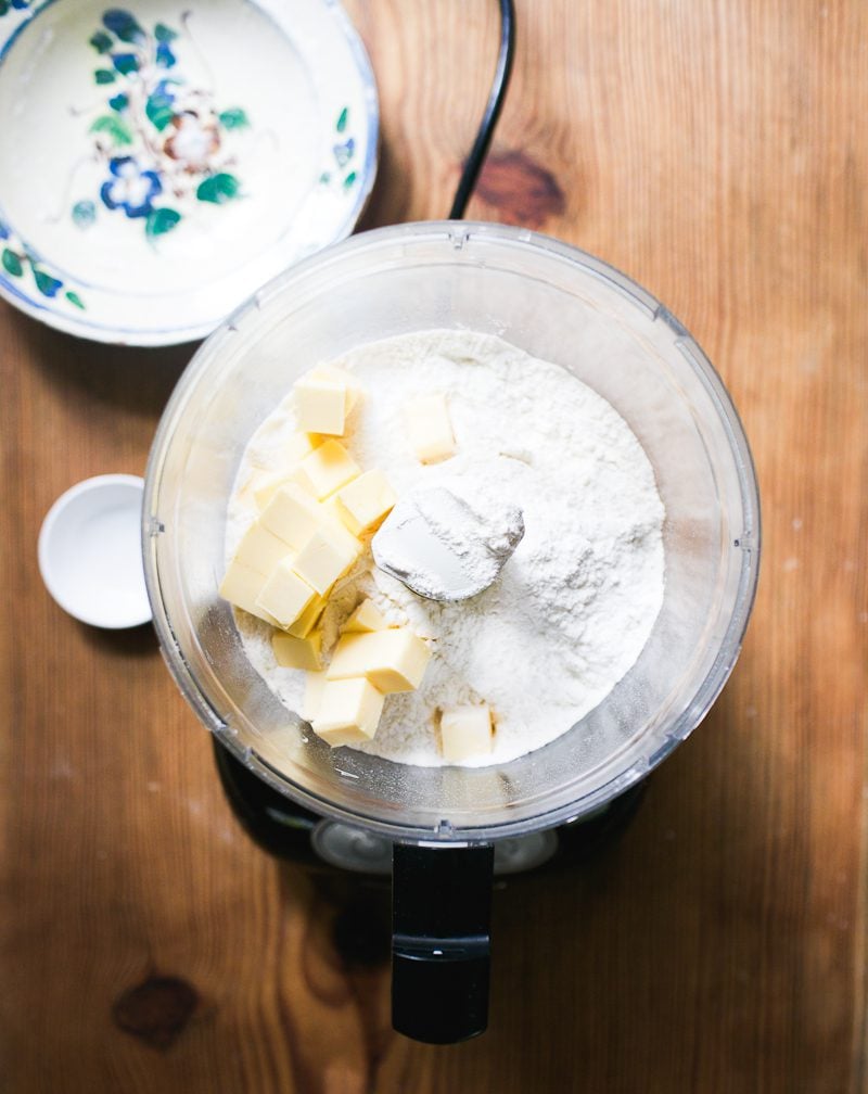 Dry ingredients in a food processor with cubed butter