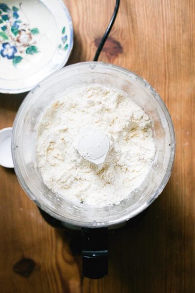 Pulsed dry ingredients in a food processor with cubed butter