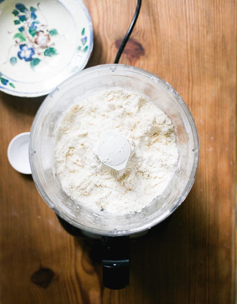 Pulsed dry ingredients in a food processor with cubed butter