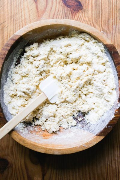 Dry ingredients & wet ingredients mixed together in a wooden bowl
