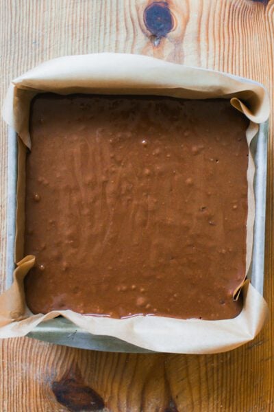 Sourdough brownie batter in a parchment lined pan