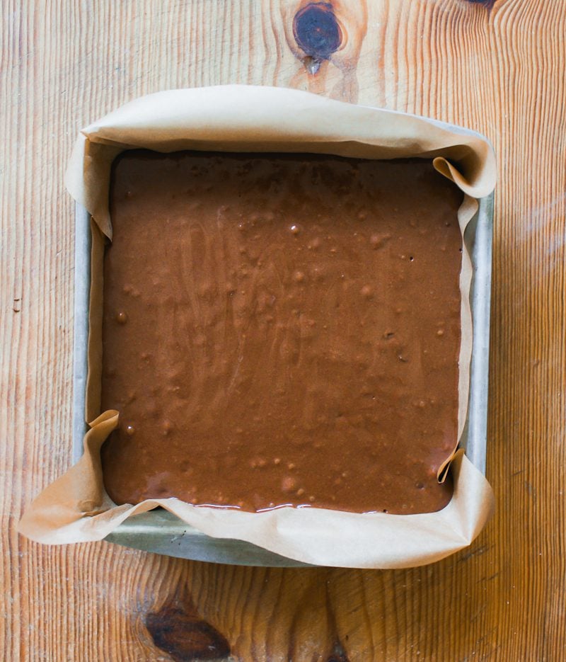 Sourdough brownie batter in a parchment lined pan
