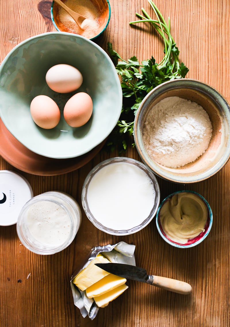 Sourdough popover ingredients: flour, eggs, sourdough starter, mustard, parsley, garlic powder, butter and milk