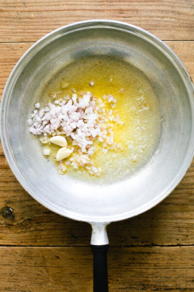Sautéed chopped shallots and garlic in a pan with melted butter