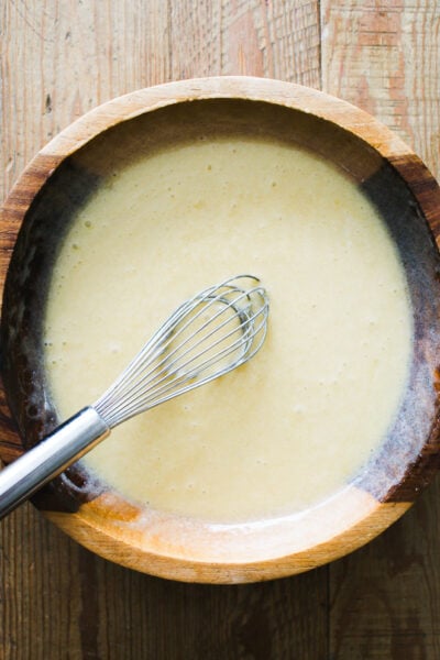 Sugar, oil, eggs, vanilla extract & sourdough starter whisked together in a wooden bowl