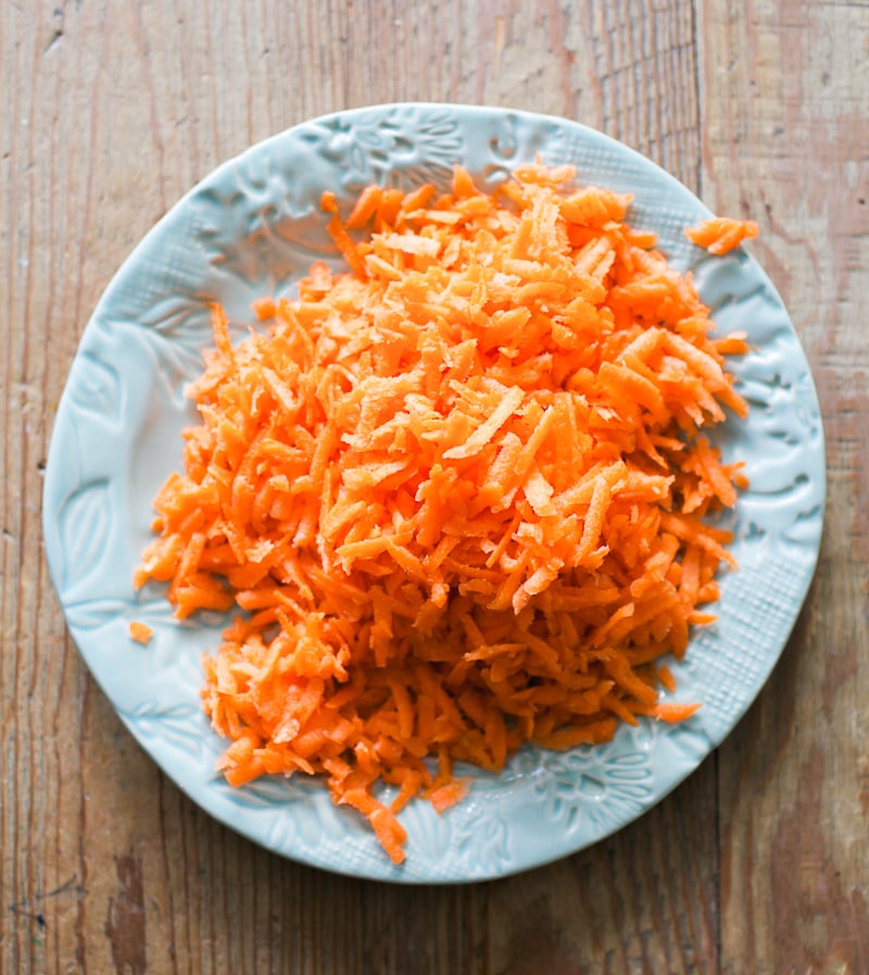Grated carrots on a blue plate
