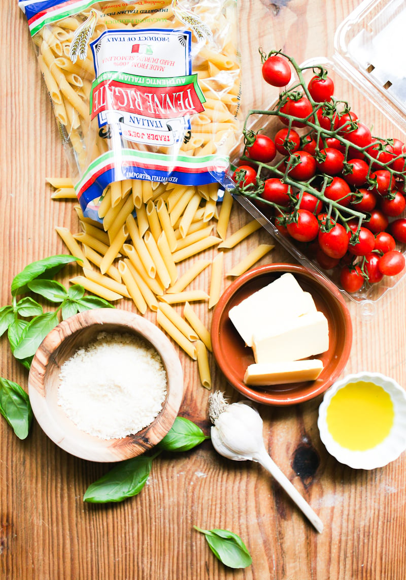 Penne pasta ingredients: penne, cherry tomatoes, fresh basil, butter, oil, garlic and Parmesan cheese