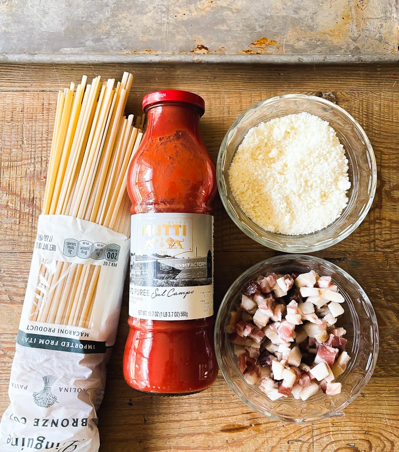 Pasta all"Amatriciana ingredients: dry pasta, tomato passata, Pecorino Romano cheese and guanciale