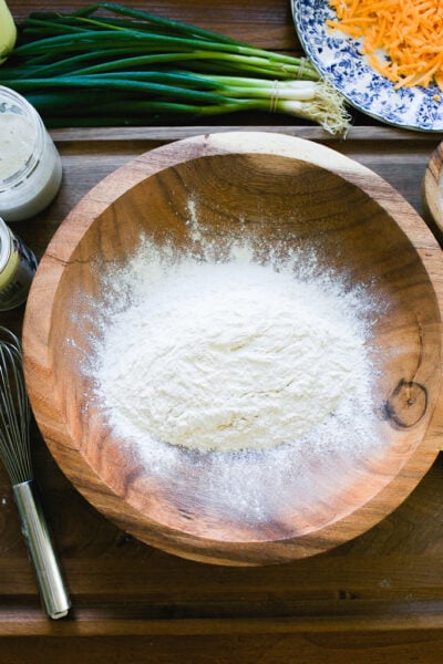 Flour, baking powder & salt in a wooden bowl