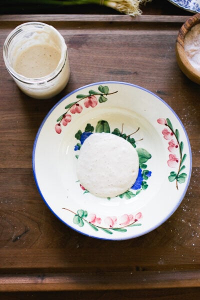 Sourdough starter and buttermilk in a small bowl