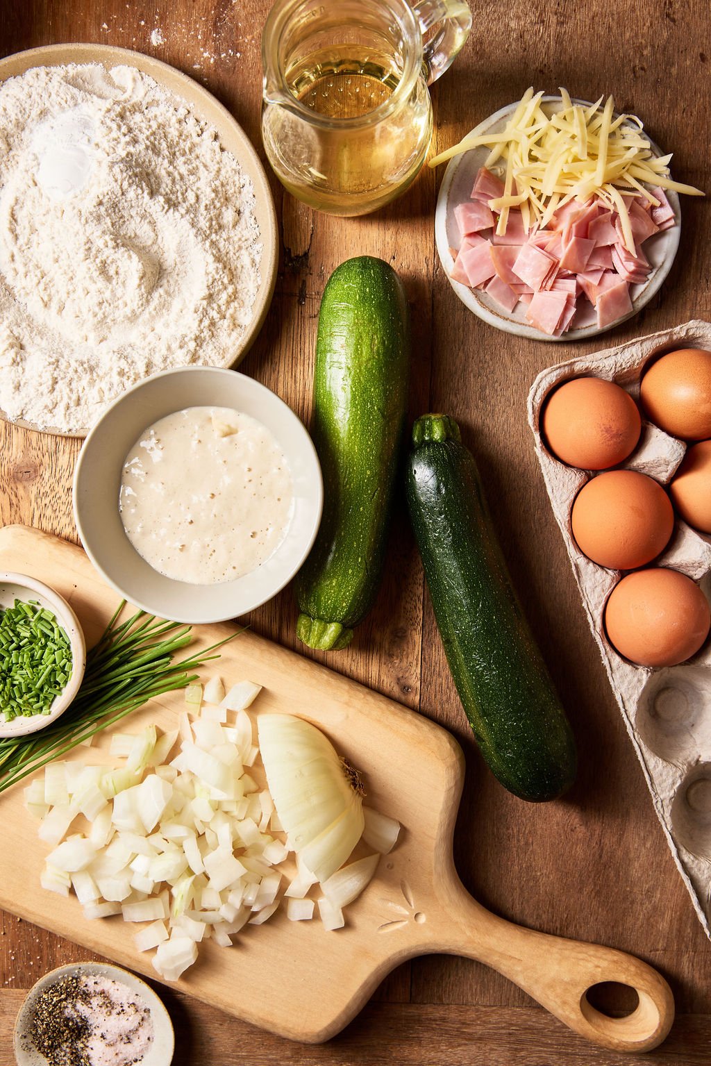 Sourdough zucchini slice ingredients on a wooden cutting board