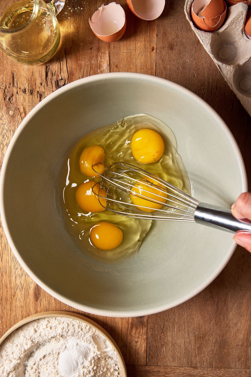 Cracked whole eggs in a large mixing bowl