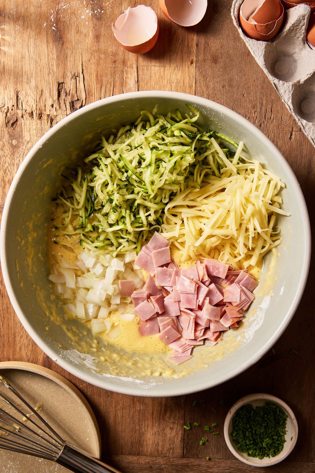 Sourdough zucchini slice batter with fillings: grated zucchini, ham, cheddar cheese, chives, eggs, salt and pepper