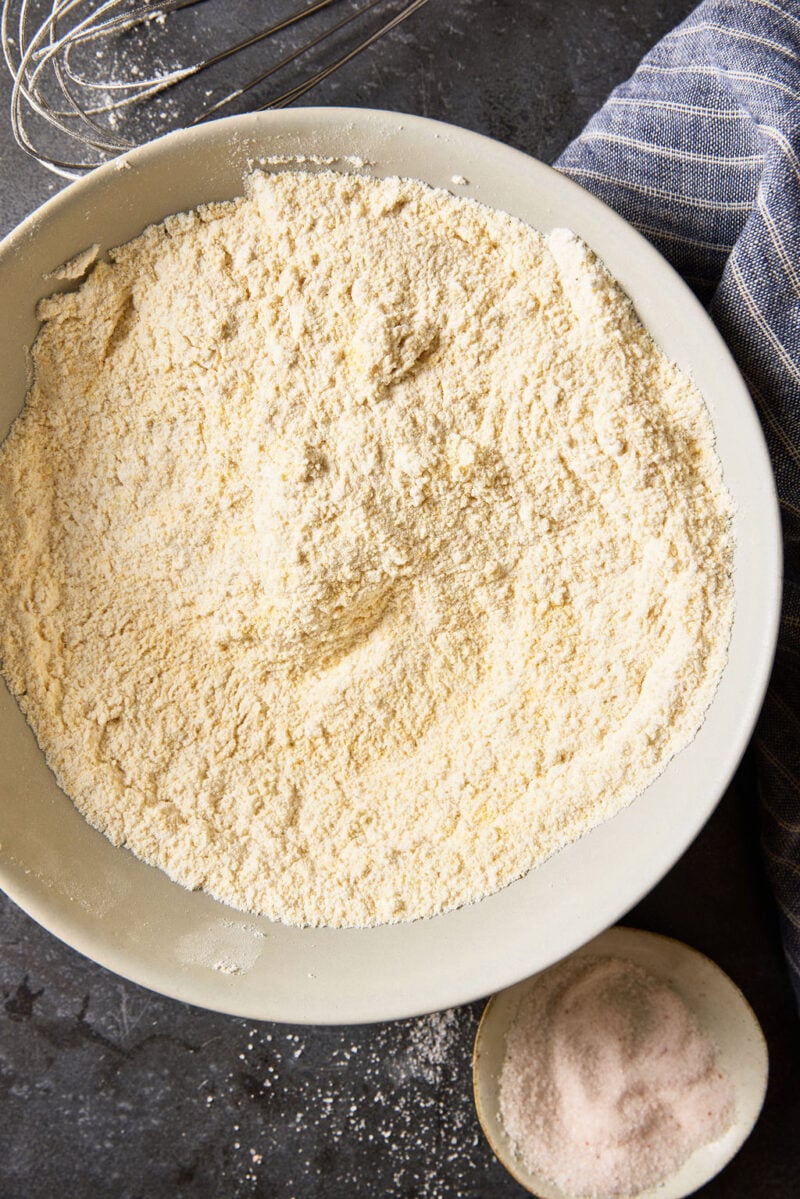 Cornmeal, flour and salt in a large white mixing bowl.