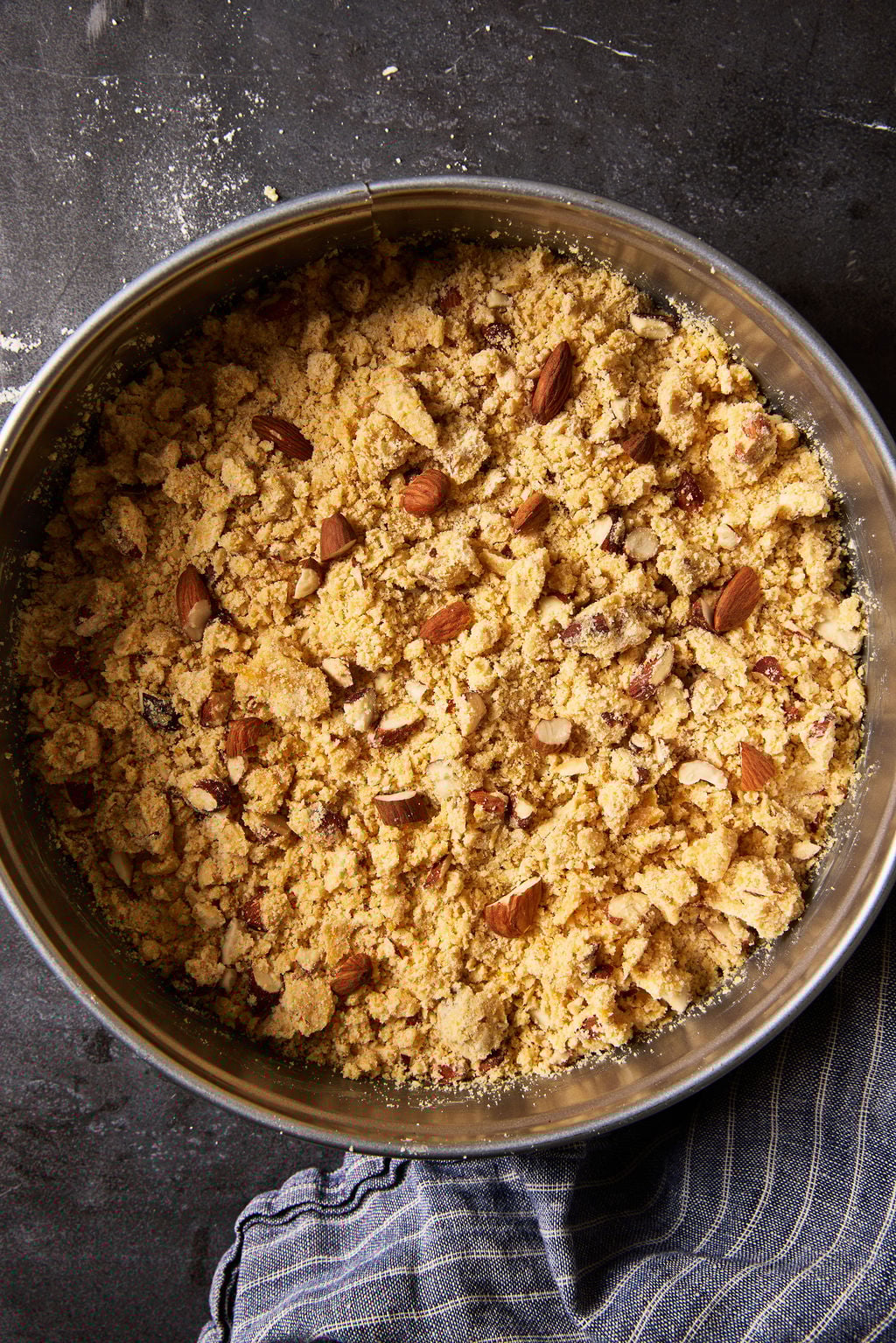 Sbrisolona in a springform pan in preparation for baking.