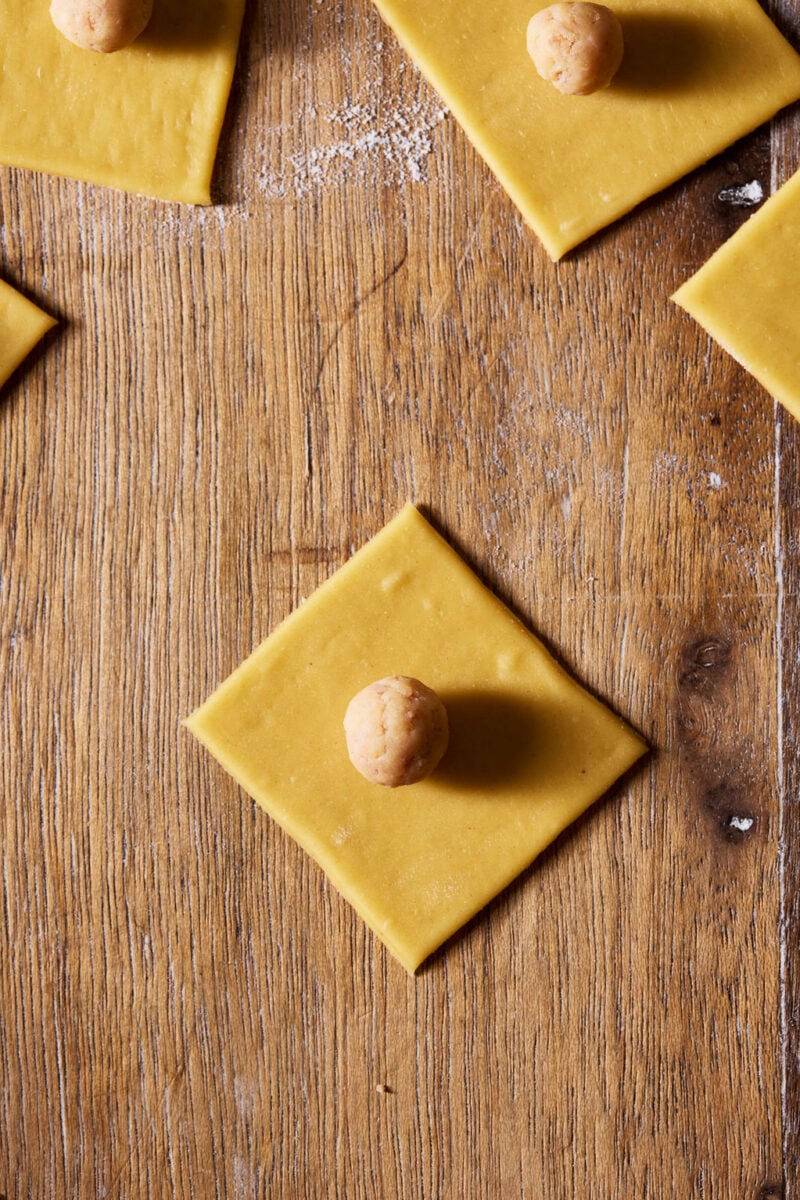 Pasta square with pork filling in the center.