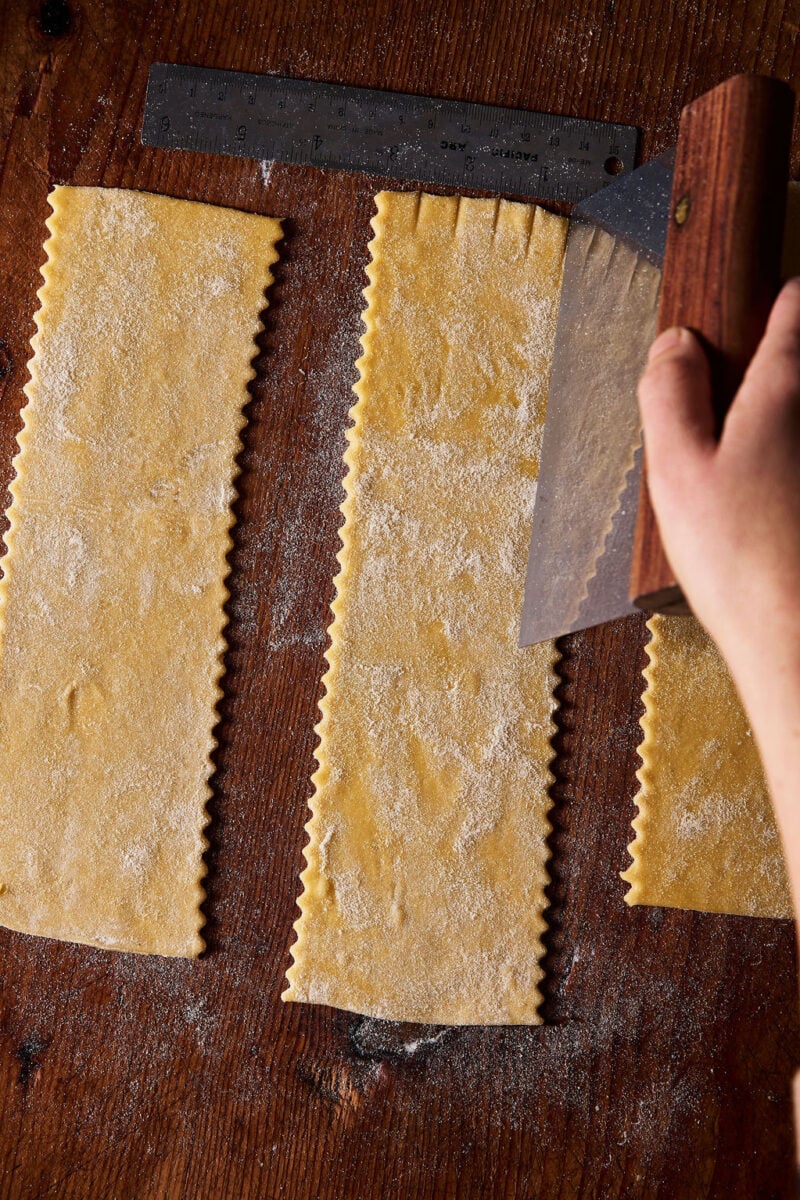 Scoring sourdough mafaldine pasta sheets by hand with a bench knife