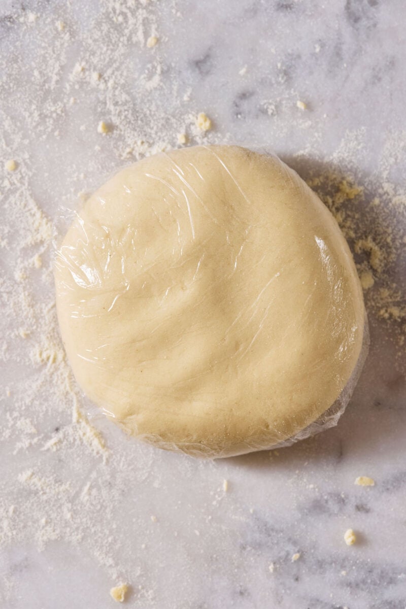 Sourdough pici pasta dough ball, wrapped tightly in plastic wrap.