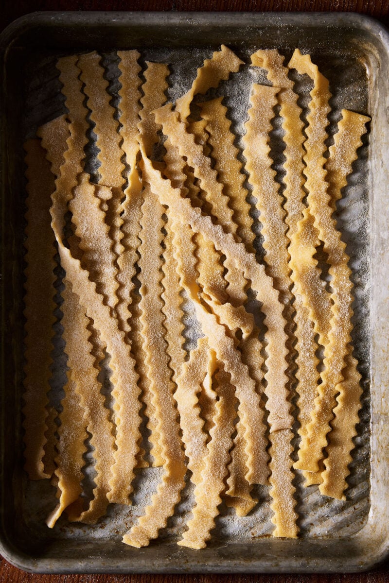 Hand-cut sourdough mafaldine on a sheet pan