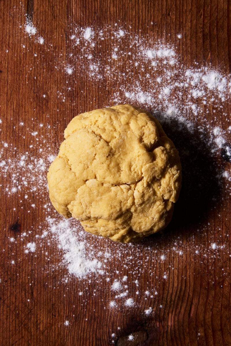 Sourdough mafaldine pasta dough in a flour-dusted wooden surface