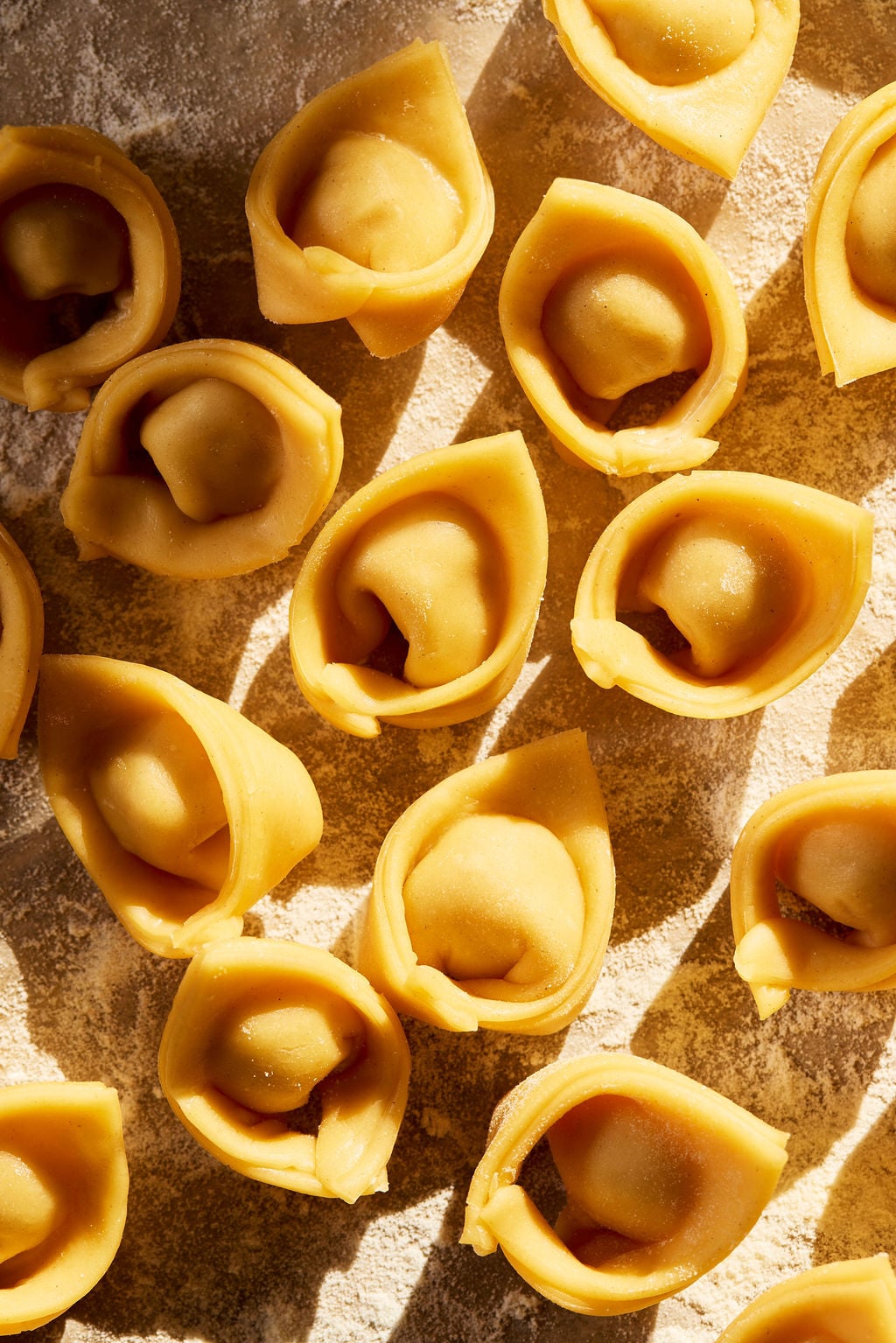 Sourdough tortellini in a flour dusted sheetpan.
