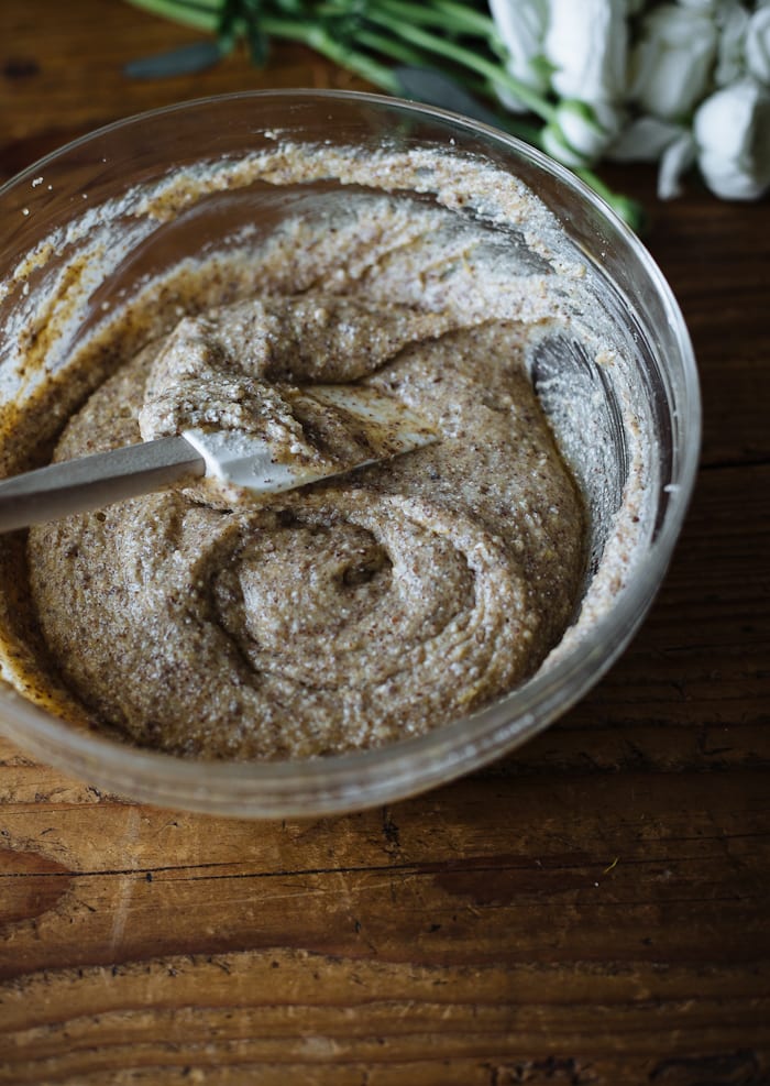 Italian almond ricotta cake batter in a glass mixing bowl with a rubber spatula.