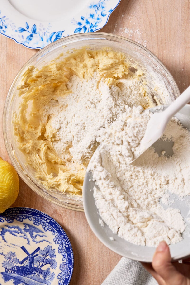 Folding dry ingredients (flour, baking powder, and salt) into the wet ingredients
