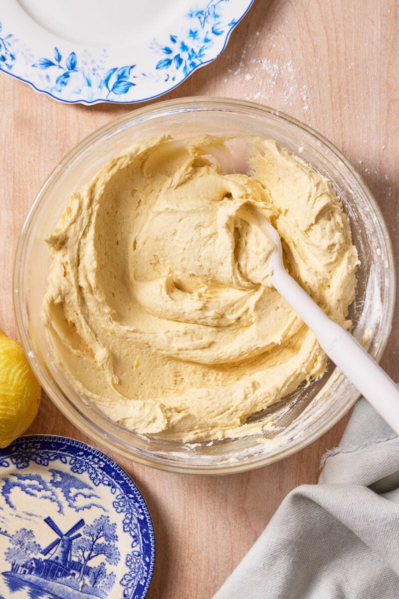 Smooth sourdough lemon drop cookie dough in a large glass mixing bowl