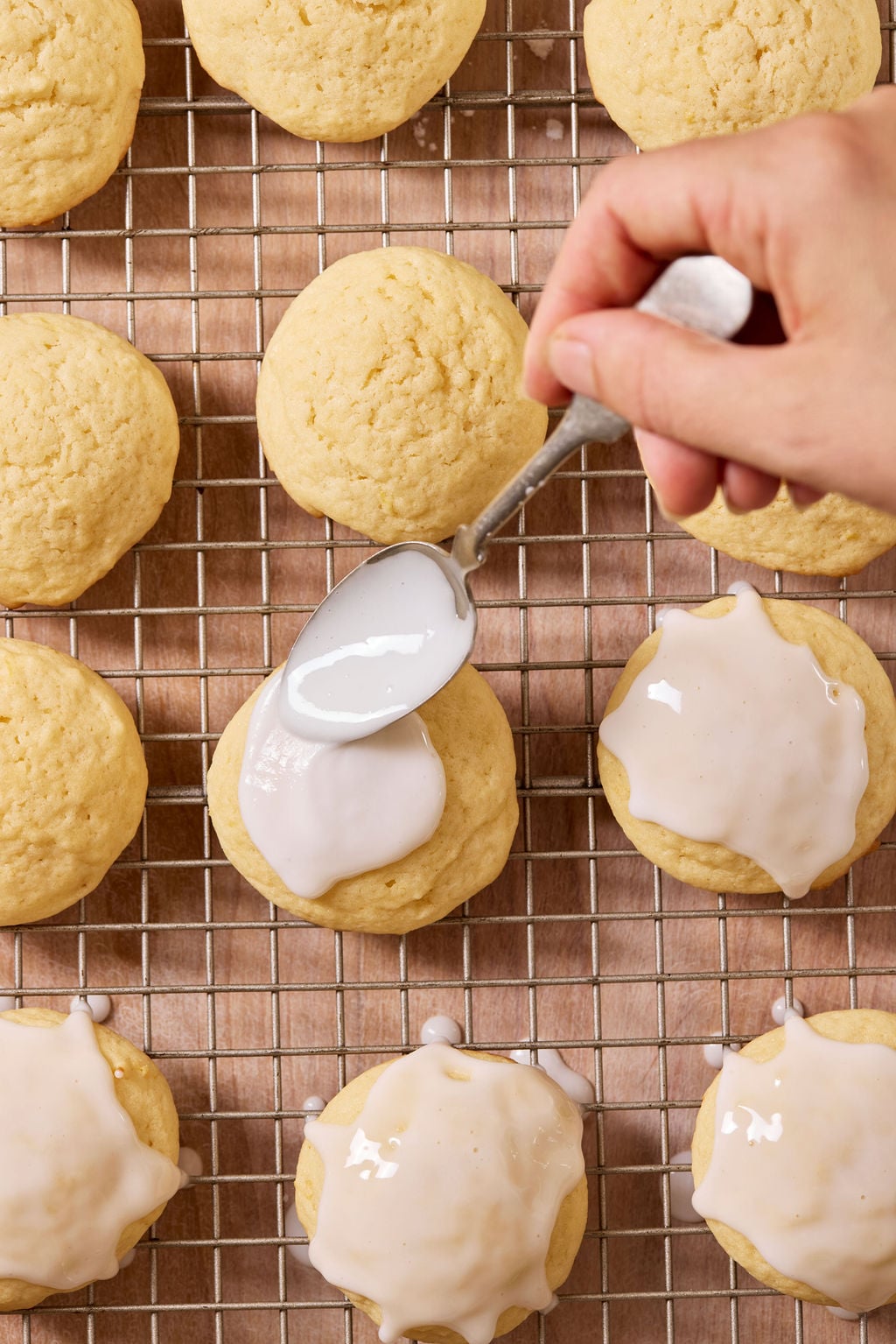 Glazed sourdough lemon drop cookies on a metal wire rack