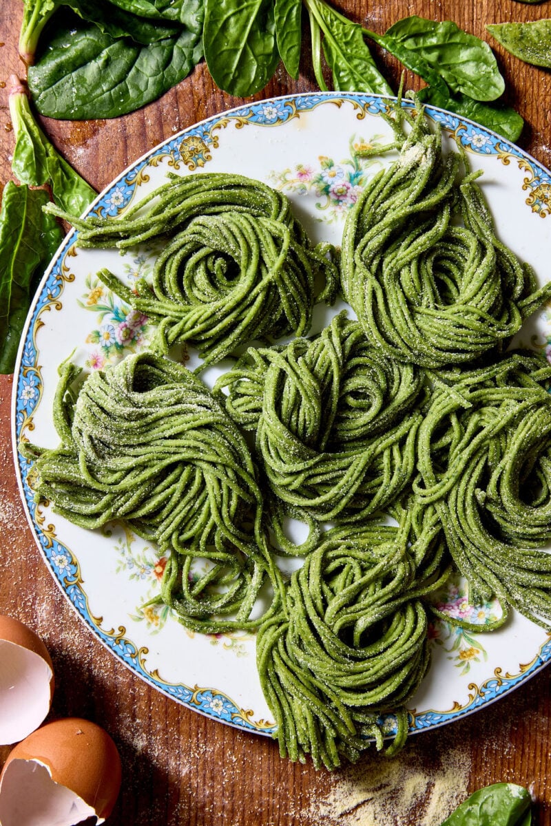 Sourdough spinach pasta on a blue-rimmed vintage plate