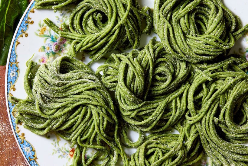 Sourdough spinach pasta on a blue-rimmed vintage plate
