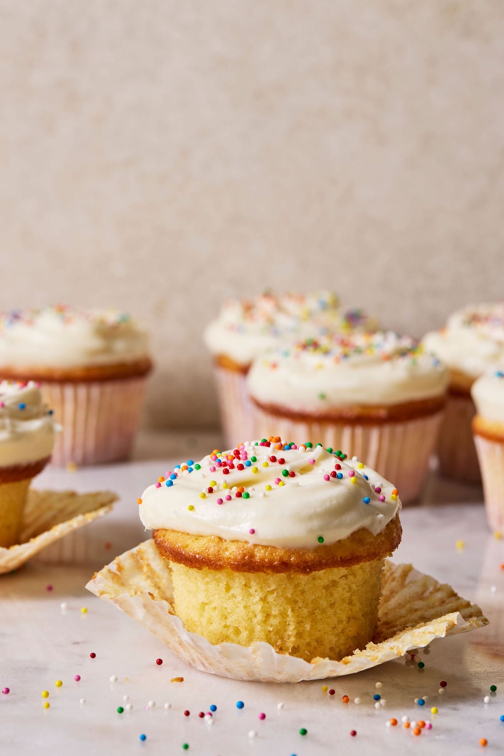 Frosted sourdough French yogurt cupcake with sprinkles.