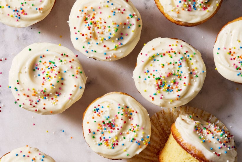 Sourdough French yogurt cupcakes with creamy vanilla frosting and sprinkles.